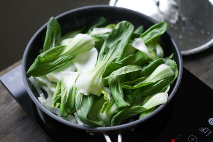 adding bok choy to the pan