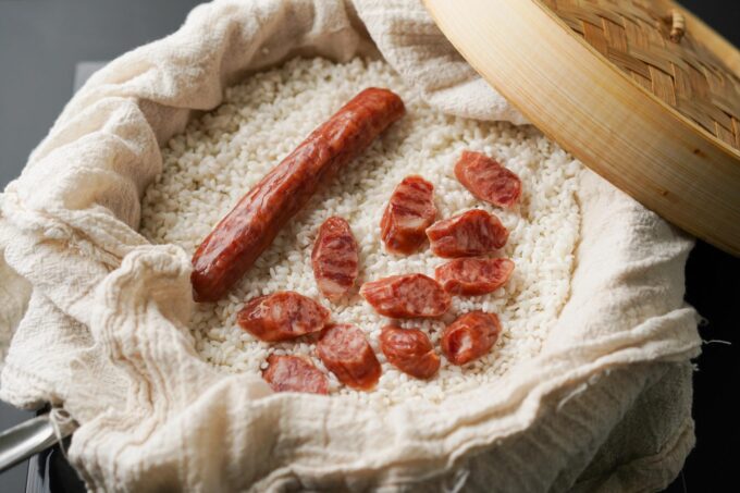 uncooked Chinese sausage in steamer