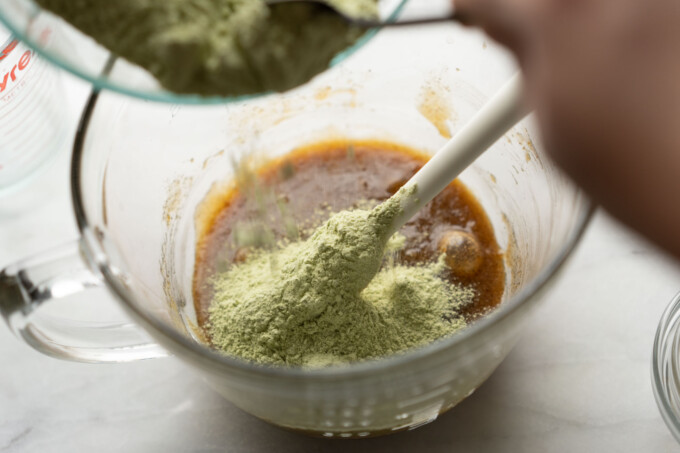 adding dry to wet matcha cookie ingredients
