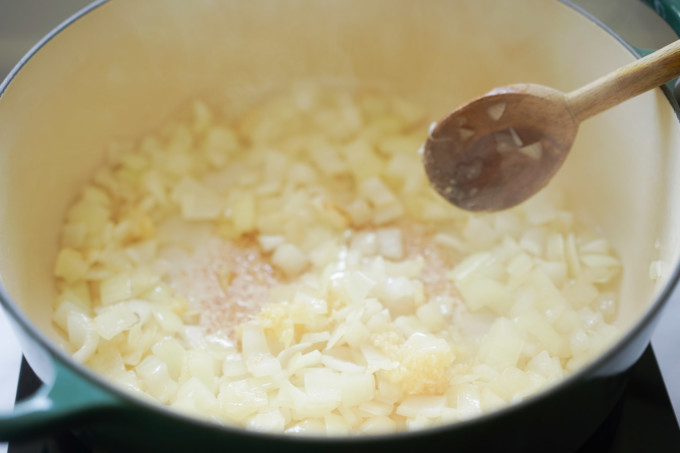 adding garlic to the pot