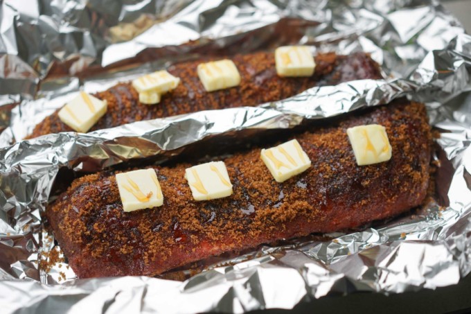 adding butter, sugar, honey on foil wrapped ribs