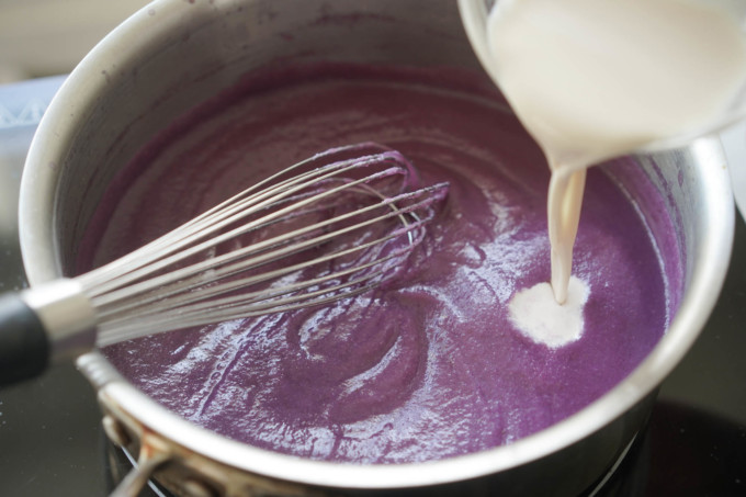 adding milk and ingredients to cooked ube powder