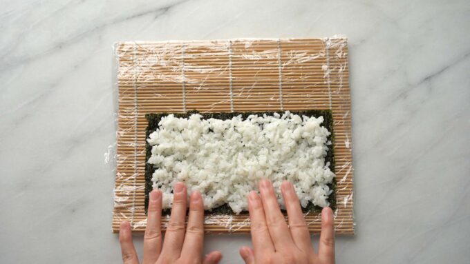 spreading out rice on nori