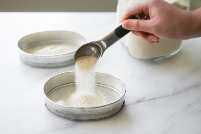 pouring sugar into the leche flan molds