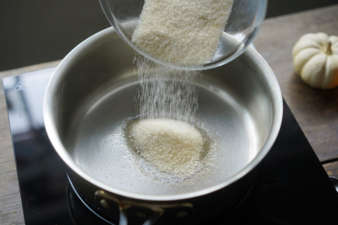 pouring sugar into a pot