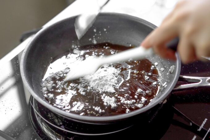 adding tapioca flour to the pan and mixing