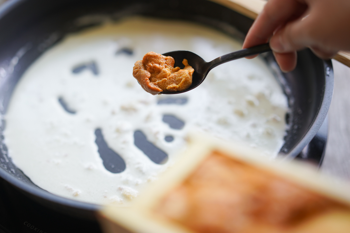 spoon of uni added to the pan