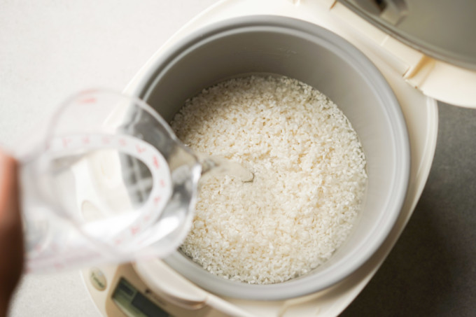 pouring water into rice cooker
