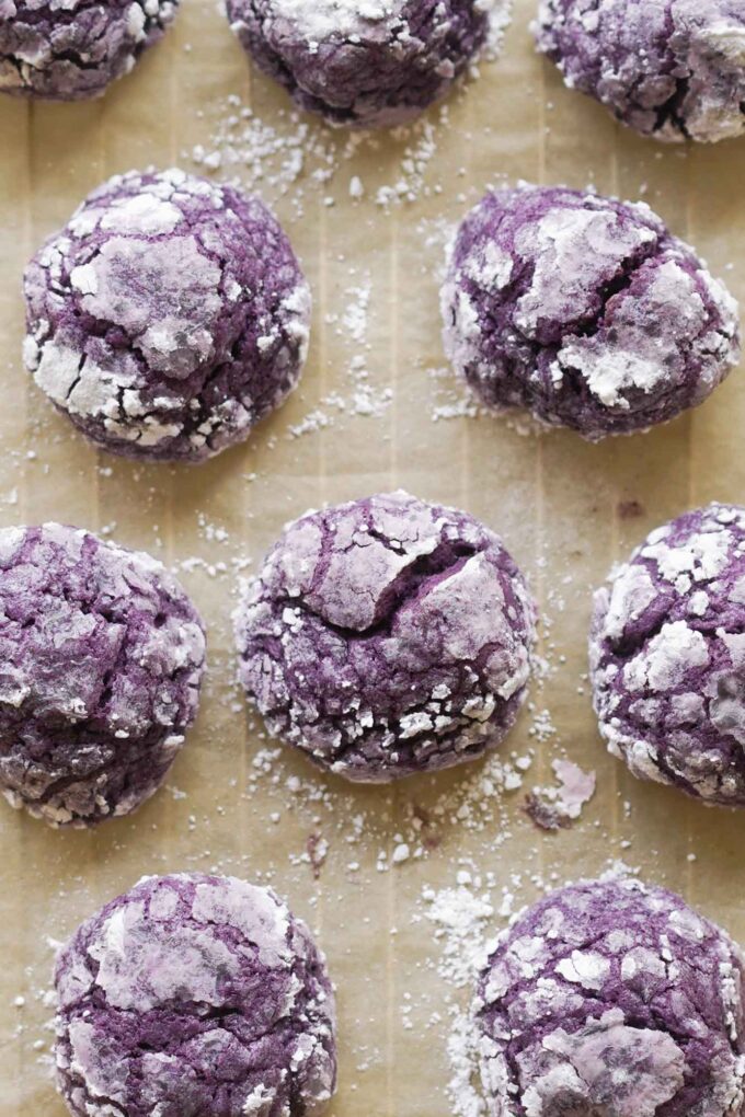 ube crinkle cookies covered in powdered sugar