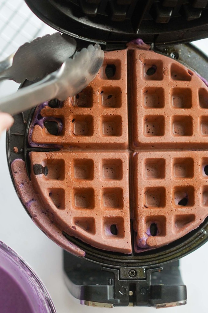 removing ube waffle from iron with tongs