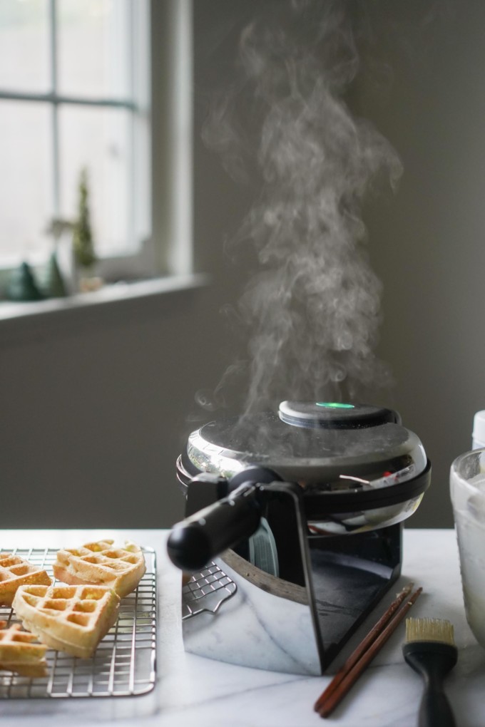 cooking vegan waffles, with steam rising