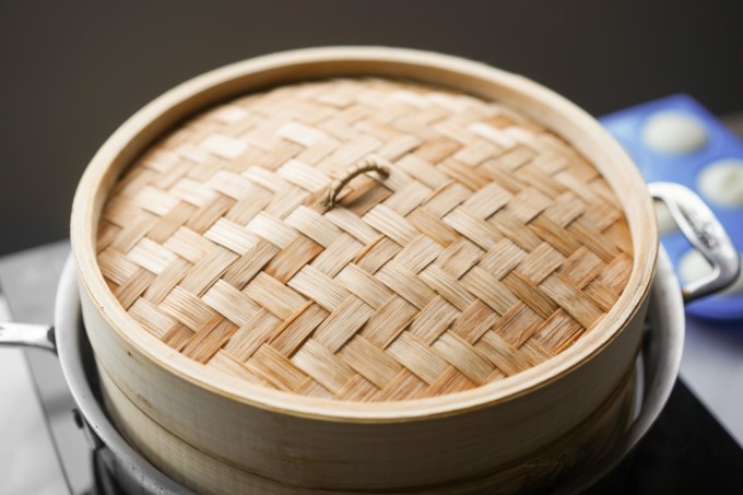 steaming puto in a bamboo steamer