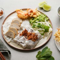 banh cuon plate with herbs, veggies, fish sauce