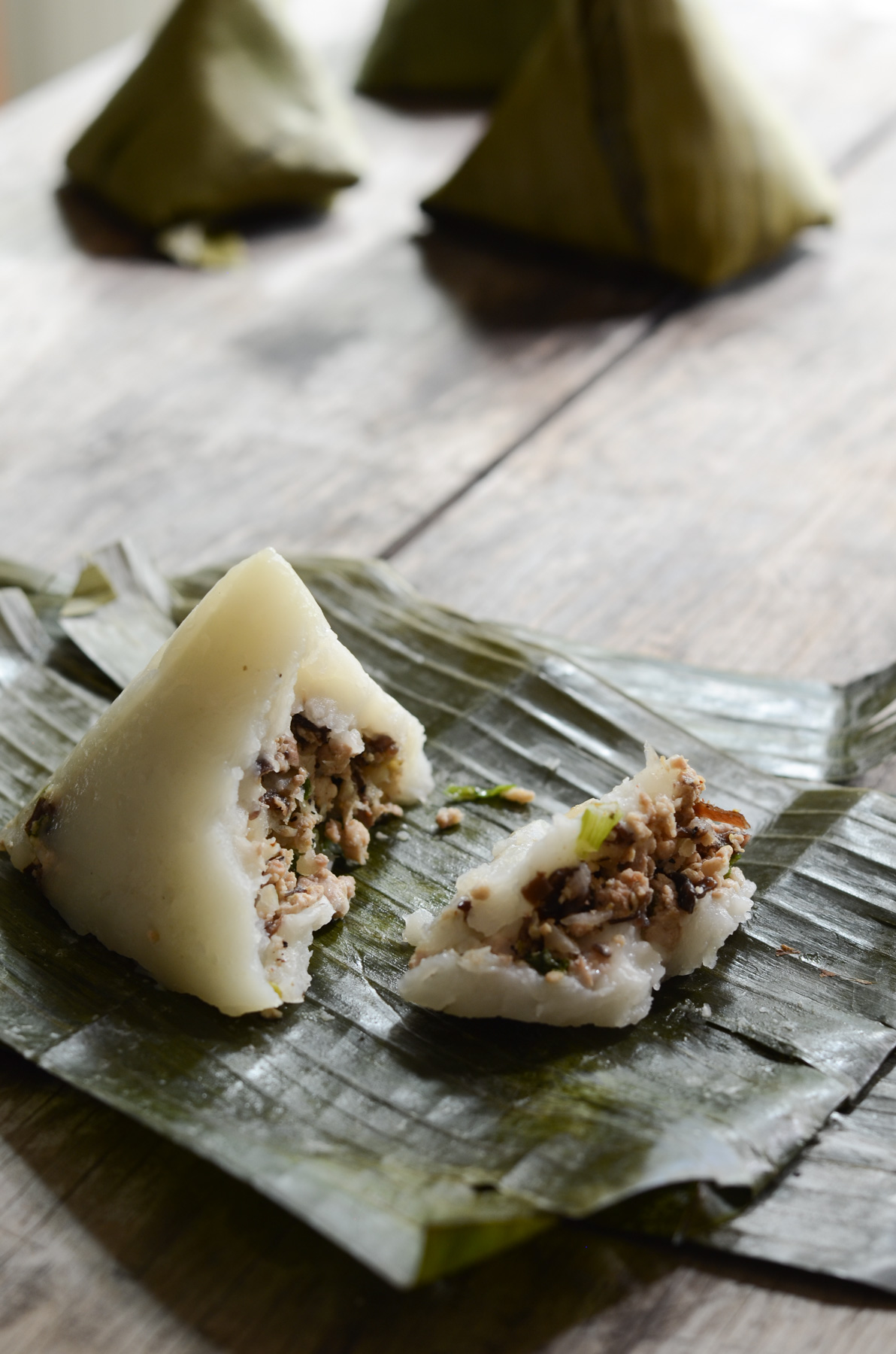 unwrapped banh gio showing filling of pork and mushroom