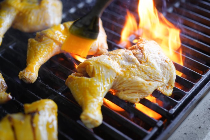 basting chicken legs on the grill