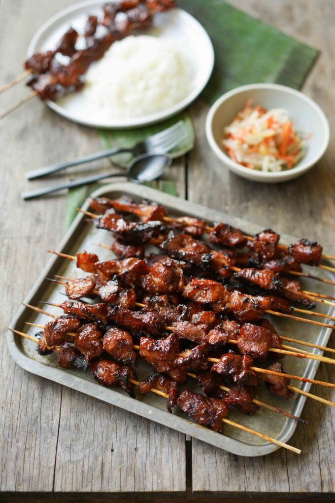 a tray of Filipino BBQ pork skewers