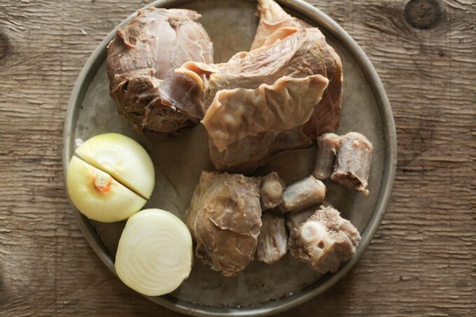 boiled meat and cut onion on a tray