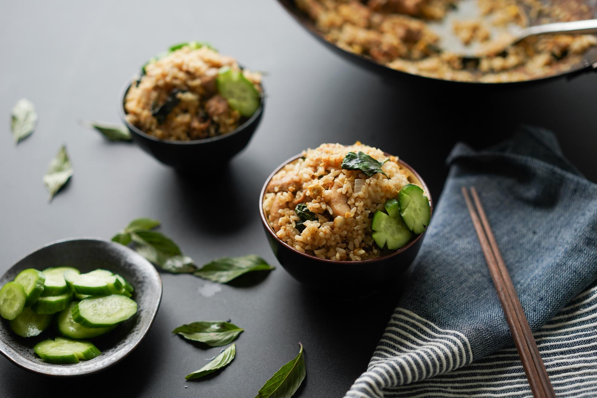 bowls of Thai fried rice with cucumbers