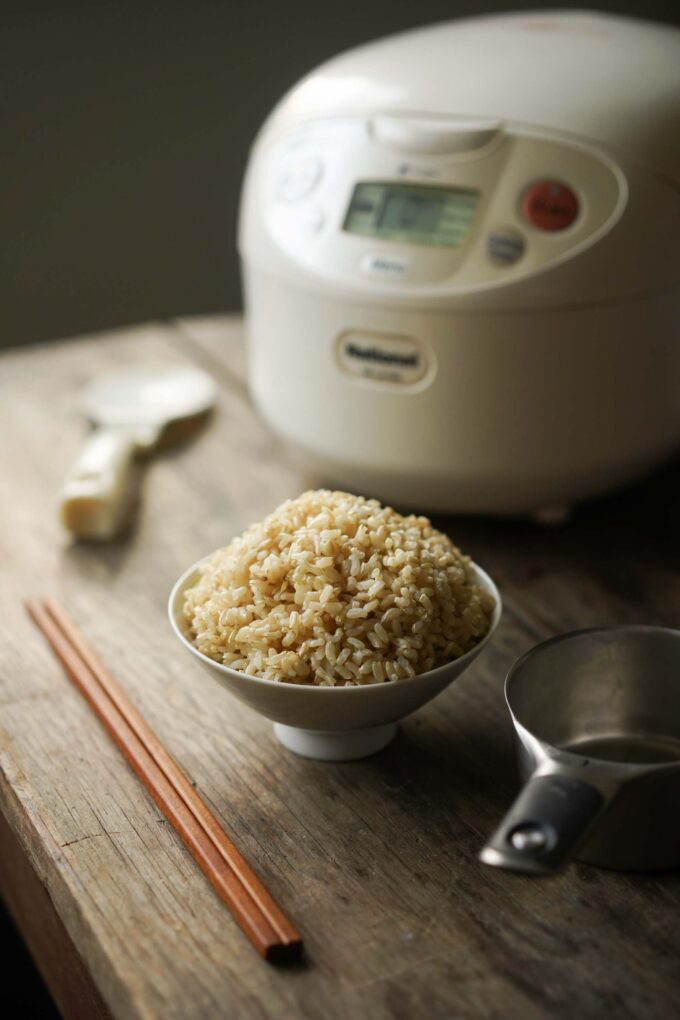 bowl of brown rice and rice cooker