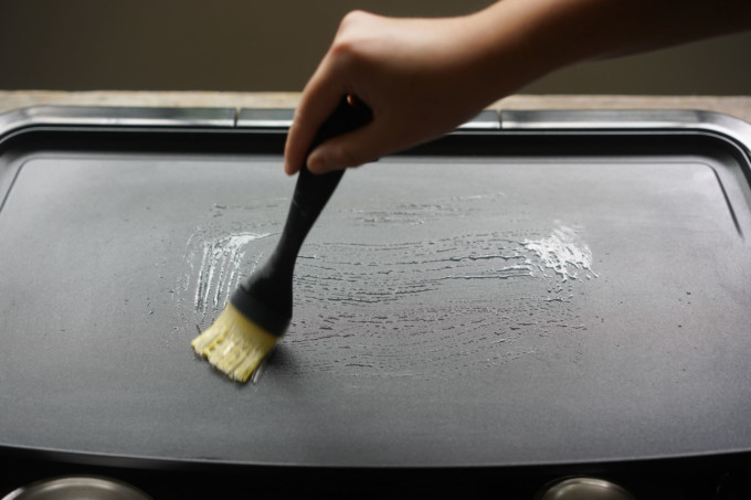 brushing oil onto electric griddle