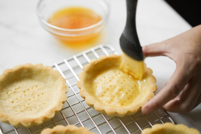 brushing tarts with the glaze