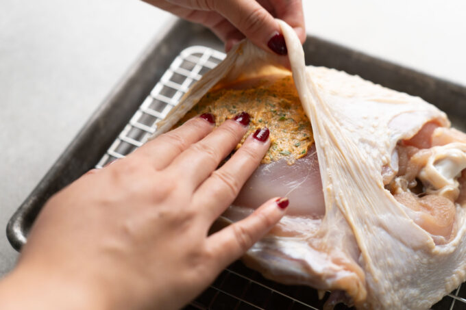 adding butter under turkey skin