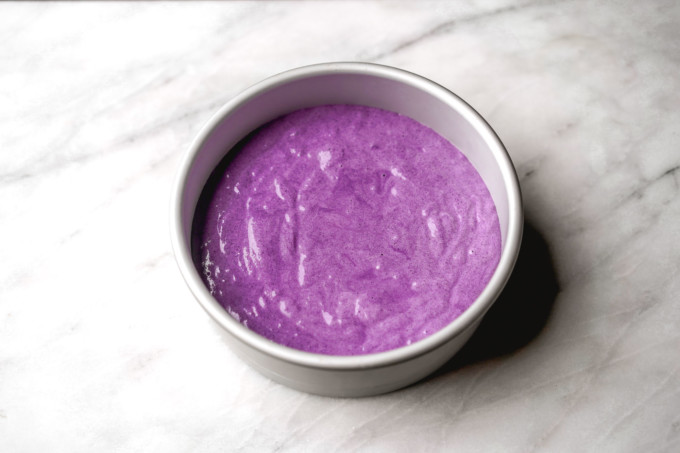 purple ube cake batter in round pan