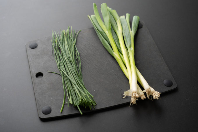 chives and green onions on cutting board