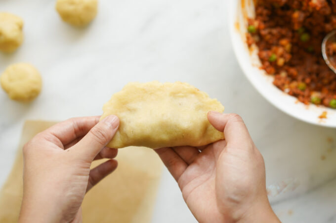 a sealed empanada with filling inside