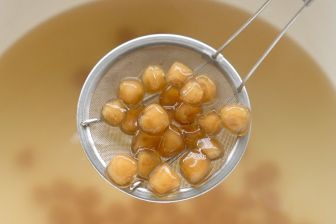 cooked boba pearls on a strainer