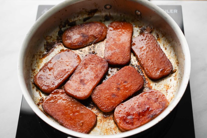 cooked Spam in pan with sauce