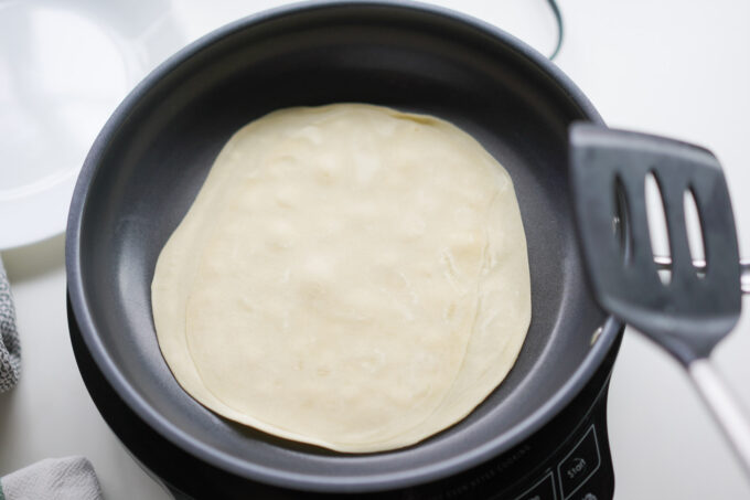 cooking spring roll wrappers in a pan