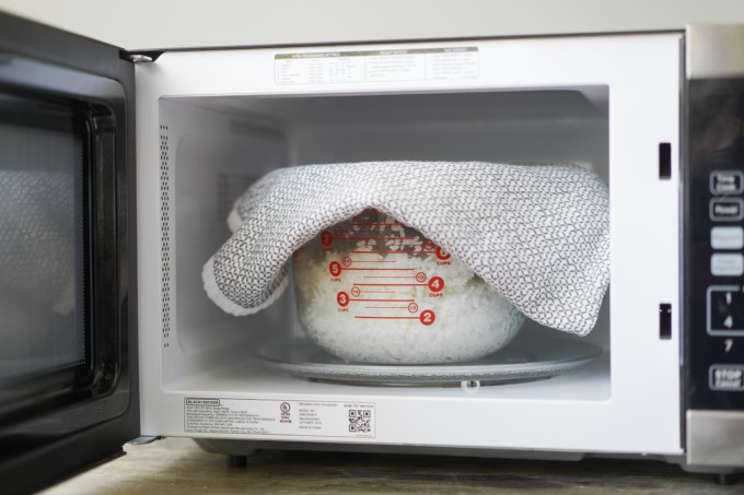 microwaving rice covered with a towel