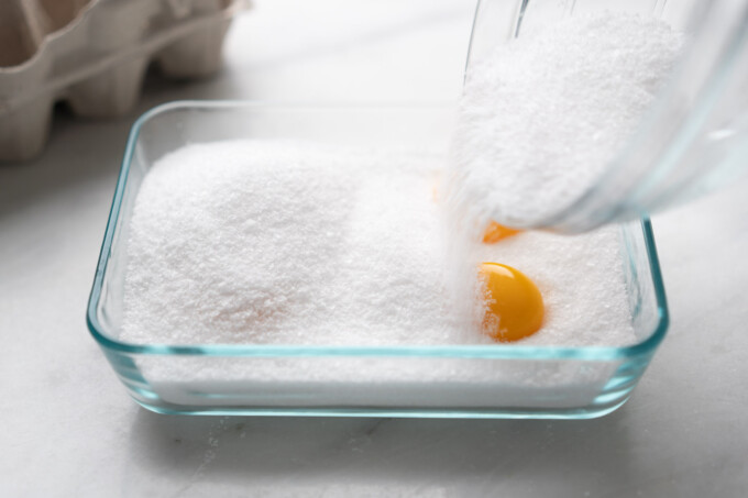 pouring salt on egg yolks