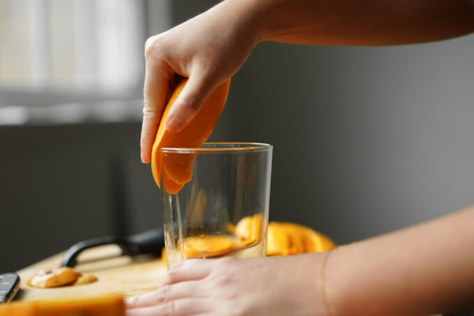 peeling a mango with a cup