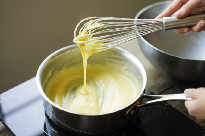 whisking tart filling in a pan