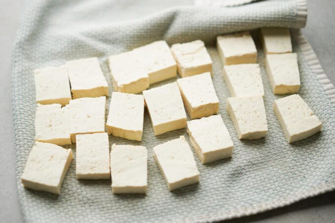 cut tofu on kitchen towel