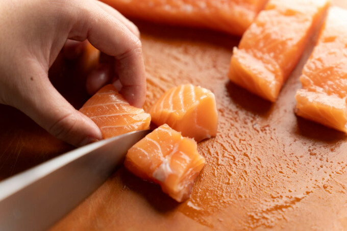 cutting salmon into cubes