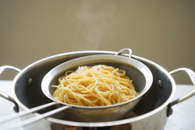 drained spaghetti on a strainer