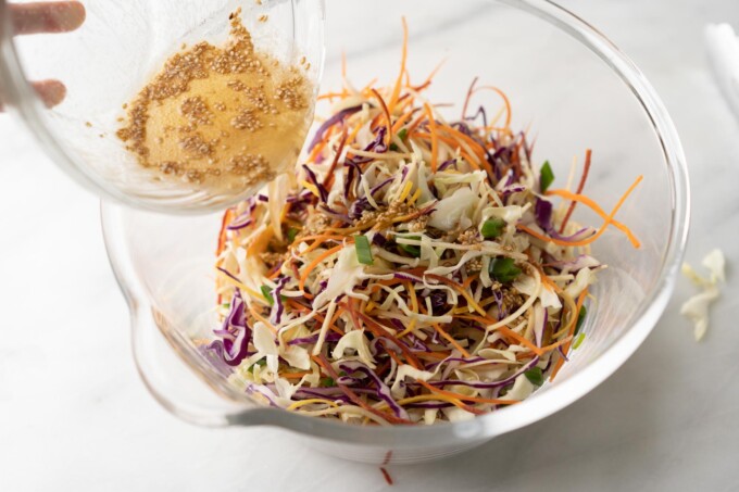 pouring dressing onto coleslaw
