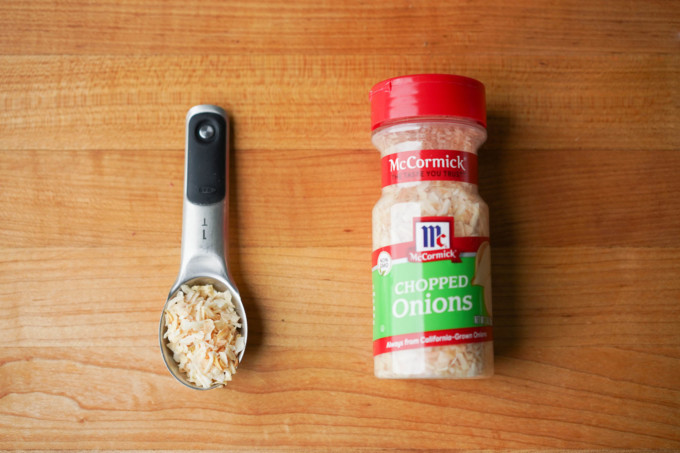 dried chopped onions in measuring spoon and bottle