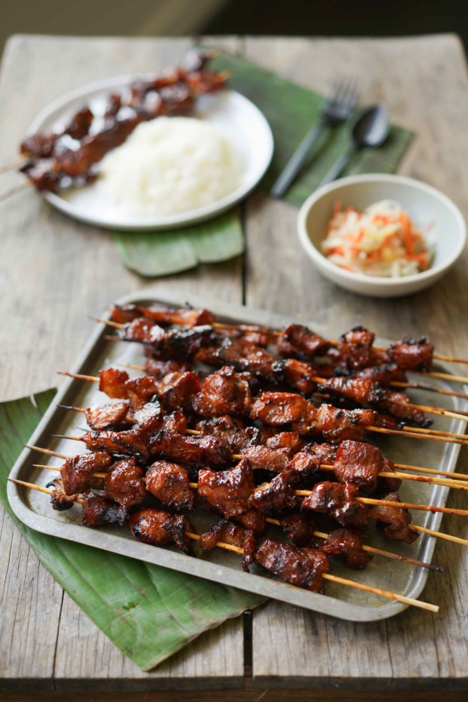 tray of Filipino bbq sticks, with plate of rice, and bowl of Filipino style pickles