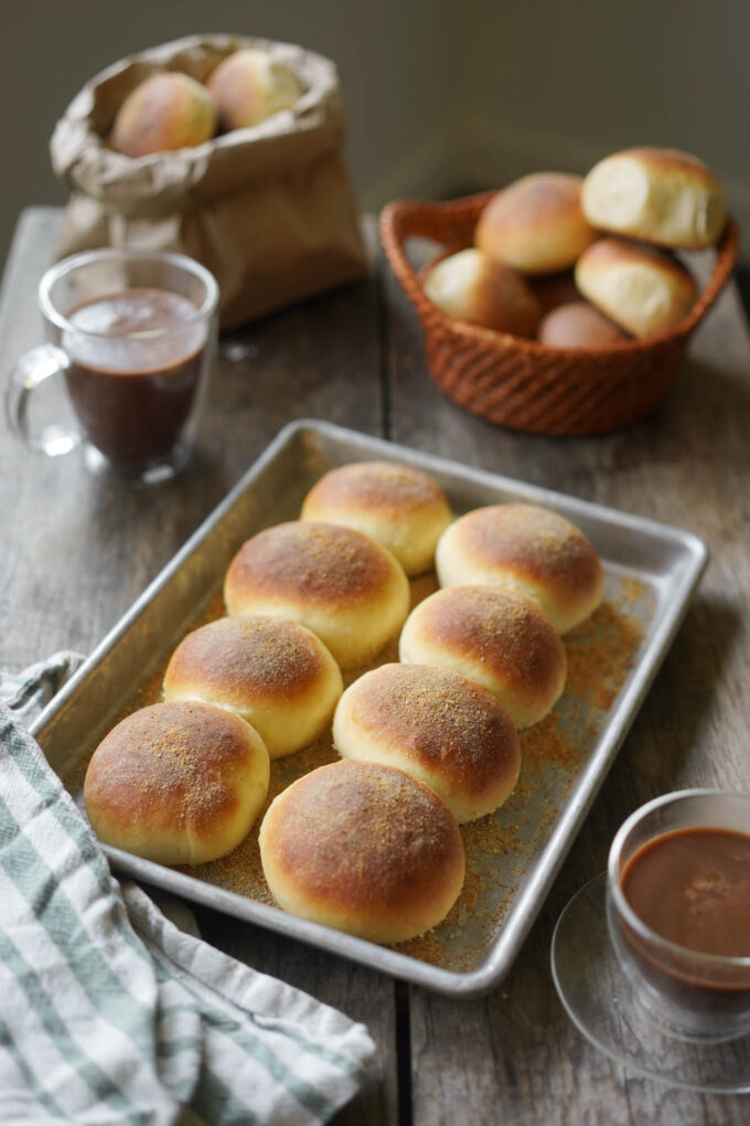 pandesal rolls on a baking sheet