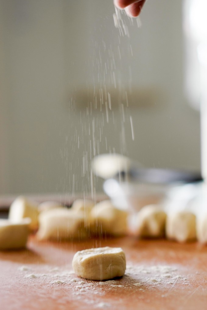 sprinkling dough balls with flour