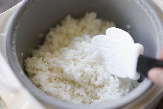 fluffing up rice with a paddle