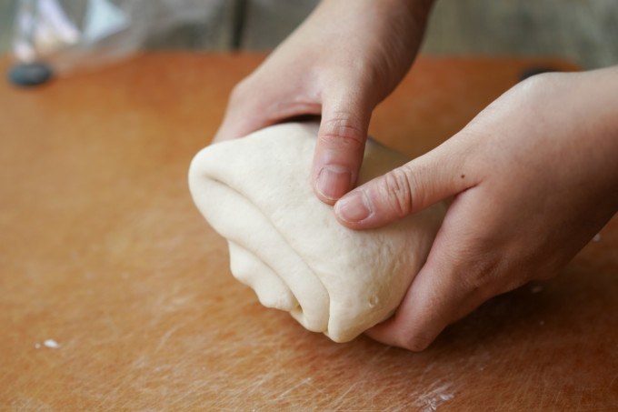 folding dough to knead again
