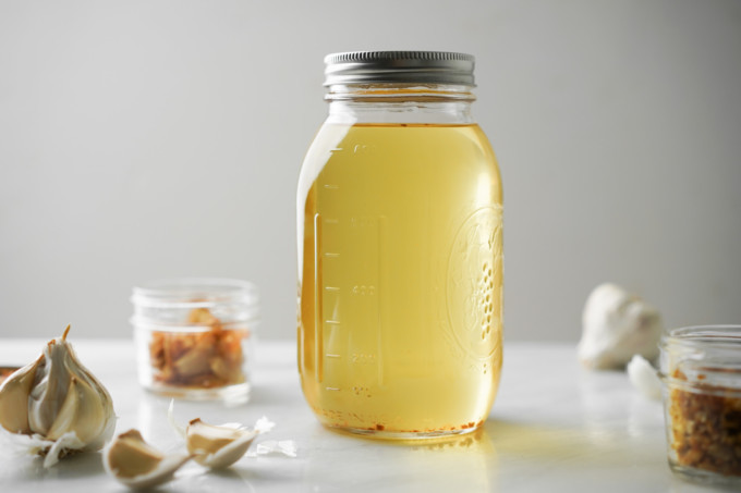 large glass jar of garlic oil