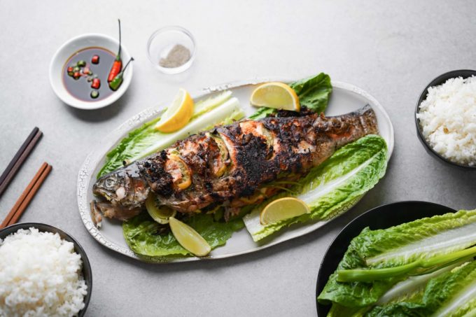 whole grilled rainbow trout with lemon and lettuce