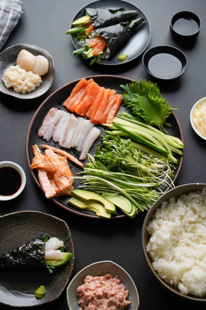 plate of hand roll ingredients, rice, fish, veggies