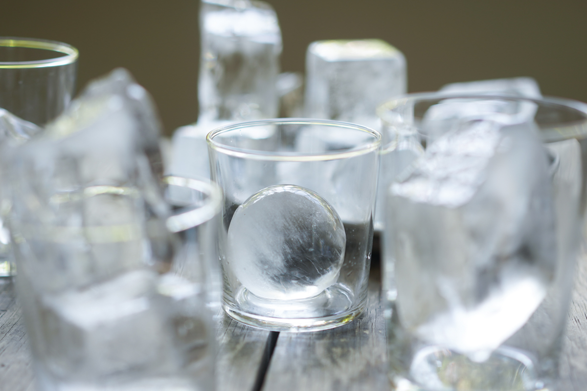 partially clear ball of ice in a glass